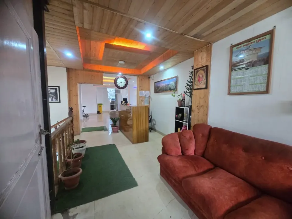 Reception lobby with wooden ceiling, wooden desk and red sofa